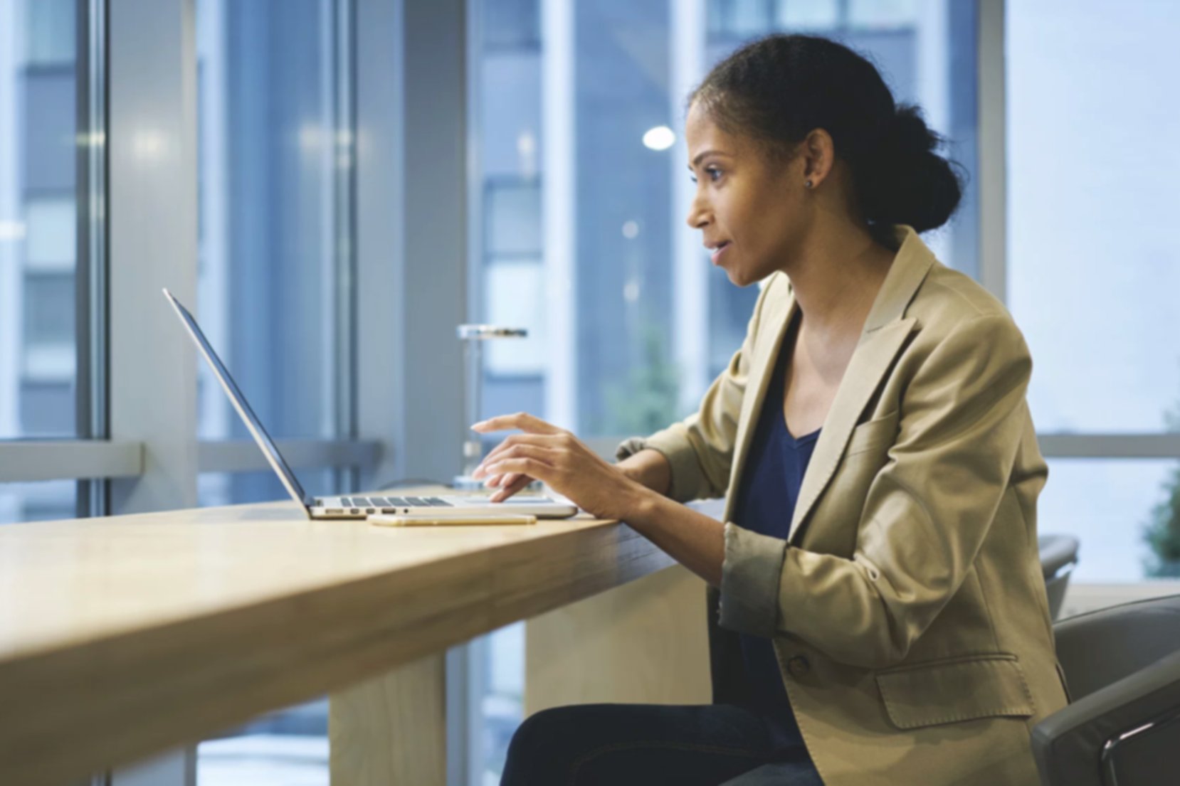A woman searches for jobs online using her laptop