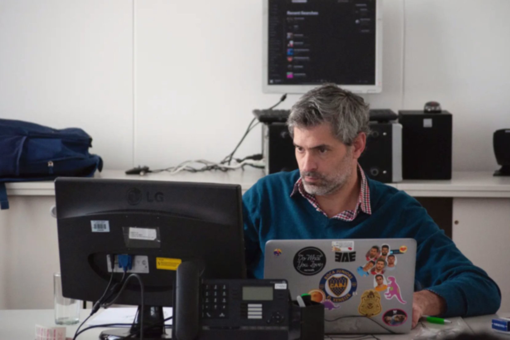 A creative-looking professional man working on his laptop in his office