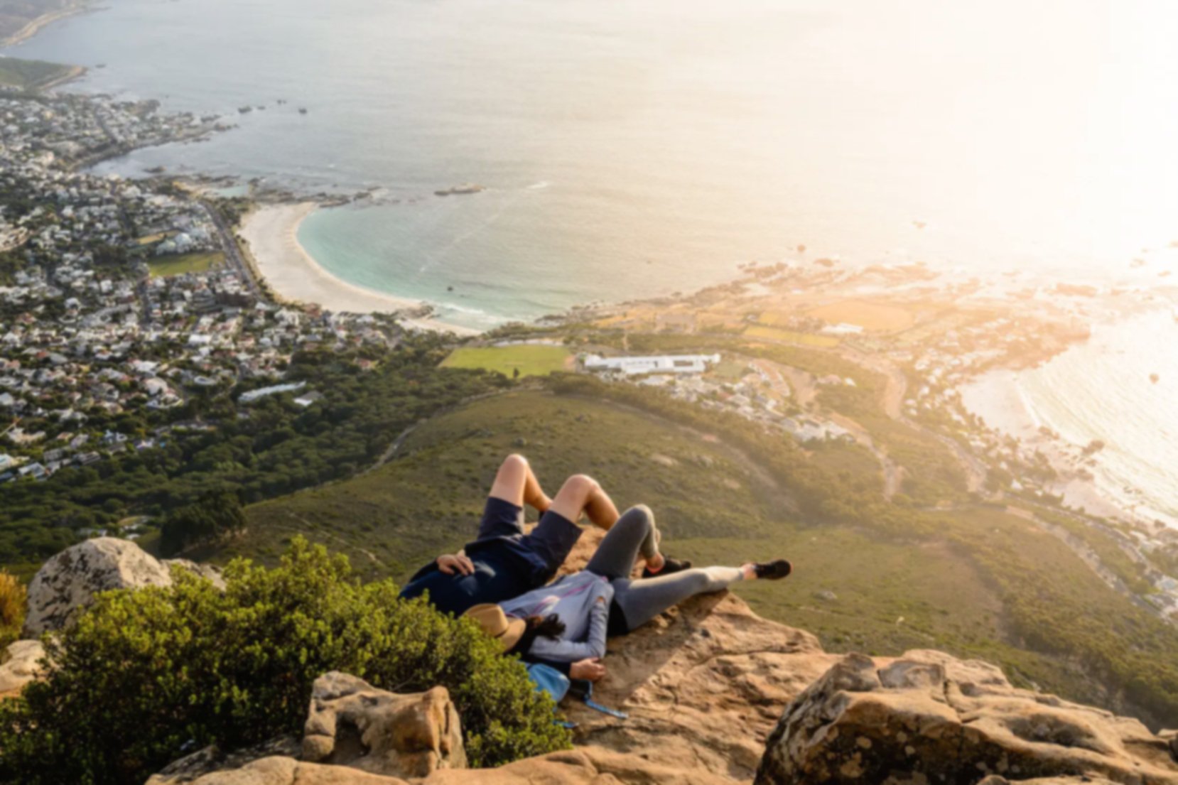 A couple enjoying the view on top of Lion's Head Mountain in Cape Town, South Africa.