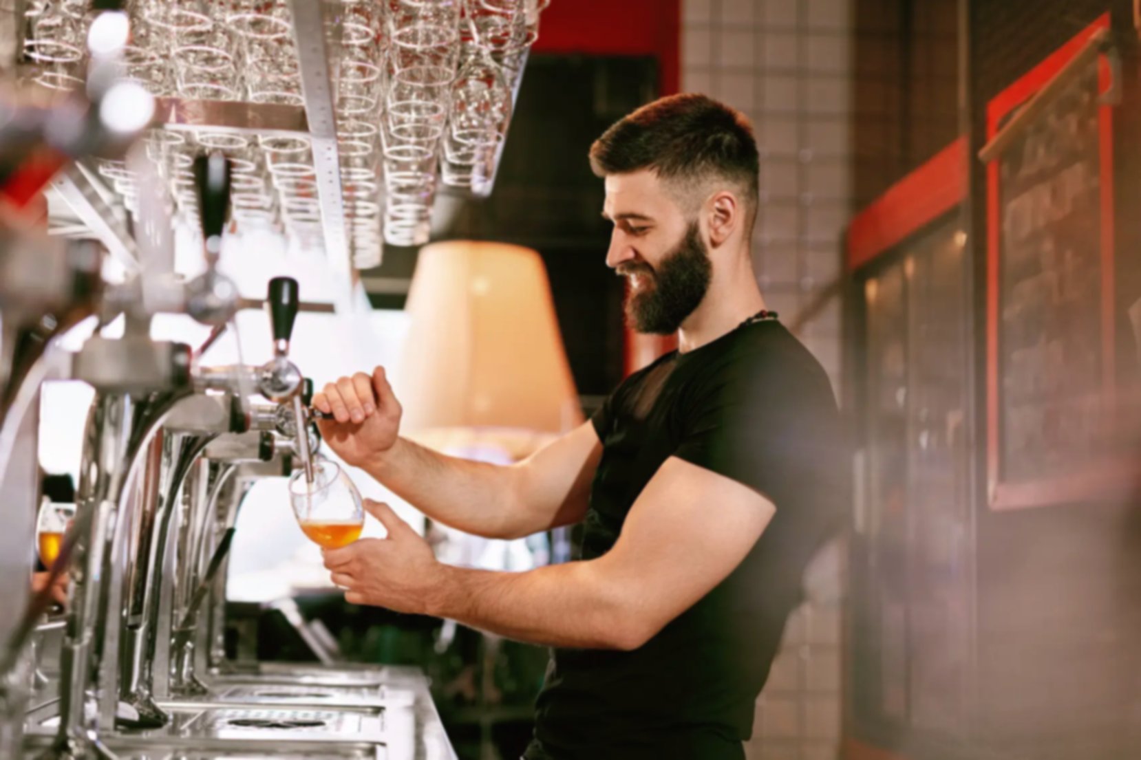 Bearded bartender working in a pub