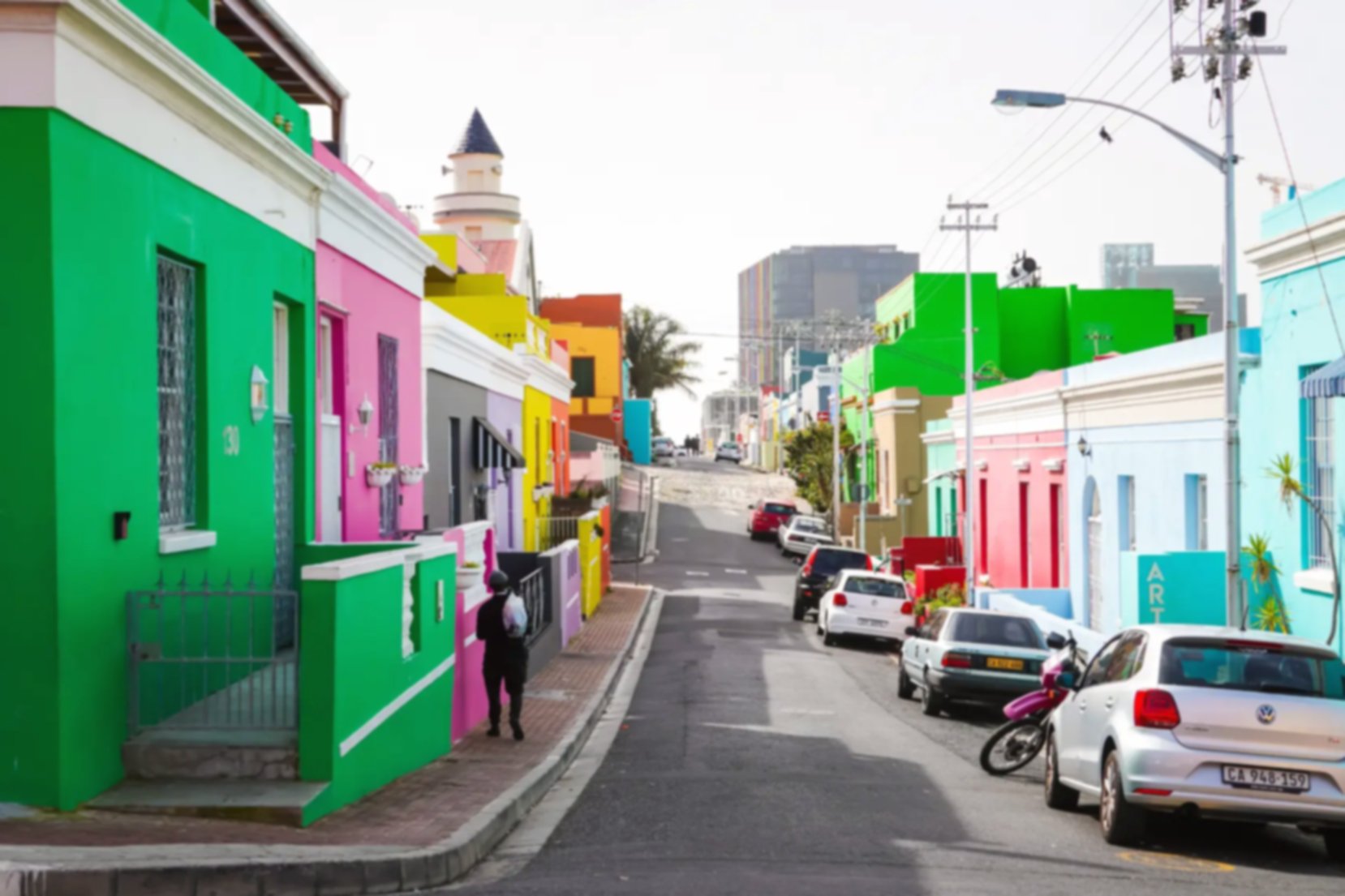 Colourful houses on a street in the Bo-Kaap, telephone lines are visible