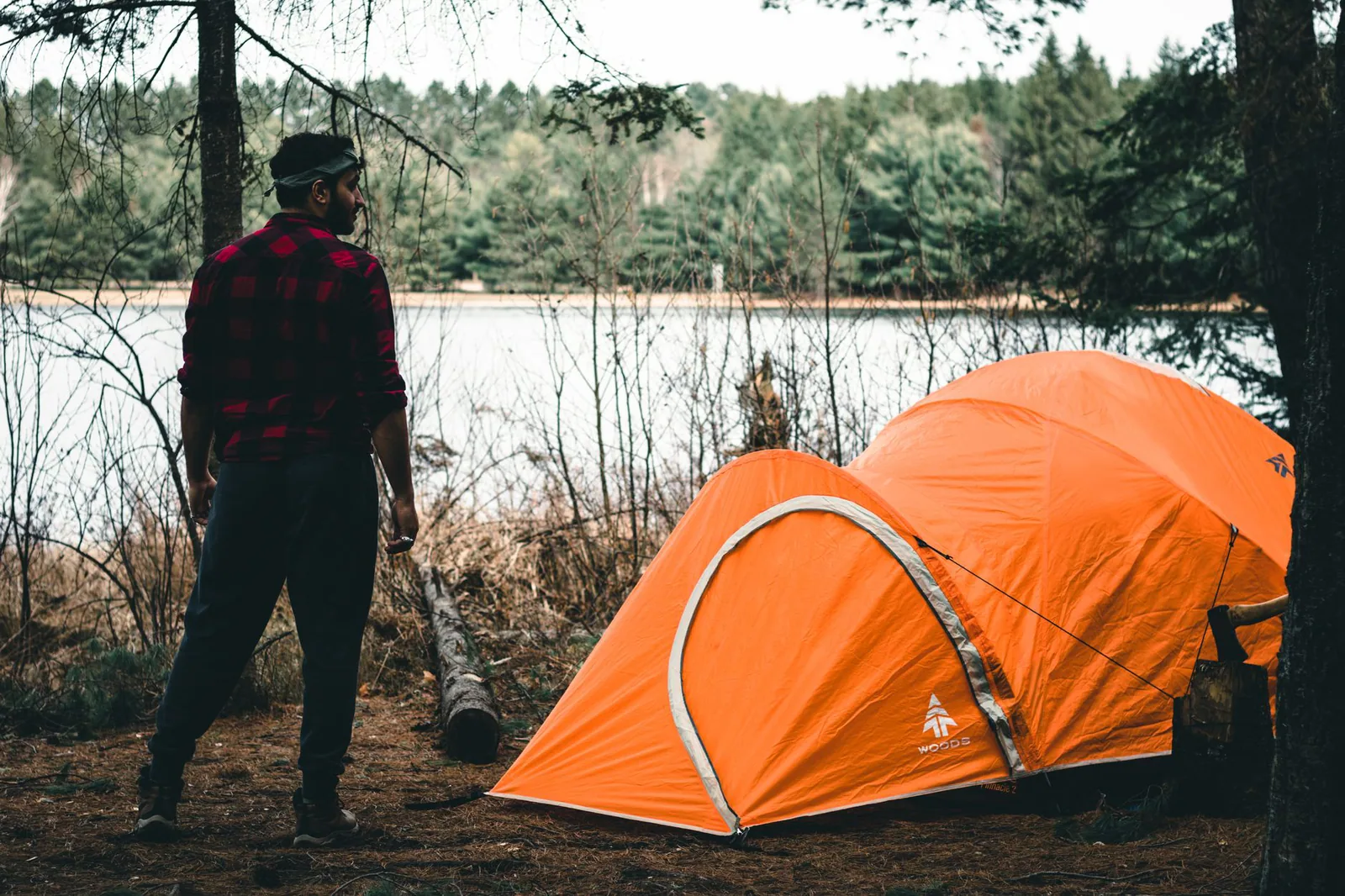 Carpa de camping al borde de un lago al atardecer