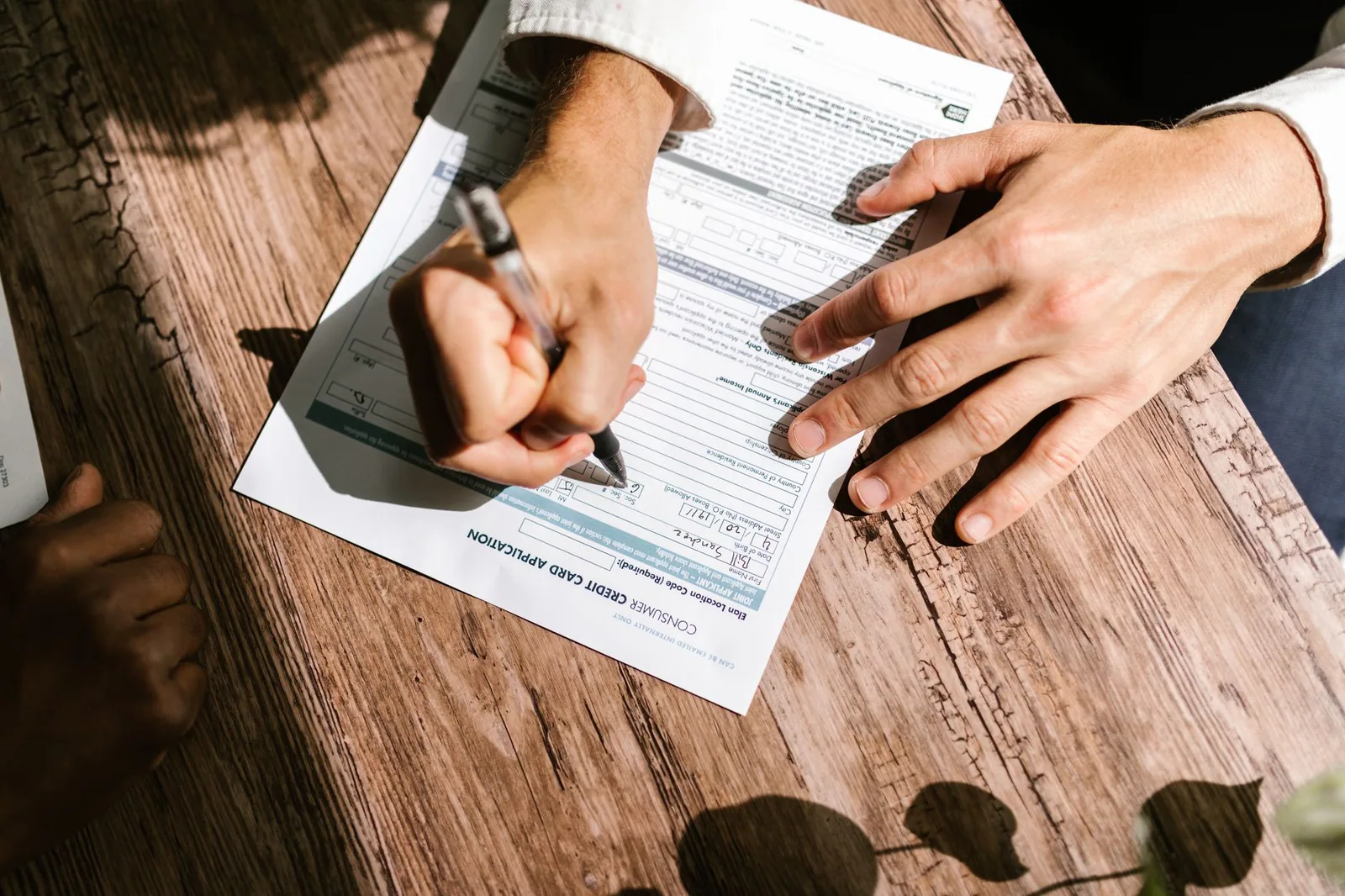 Persona firmando contrato de préstamo en oficina bancaria